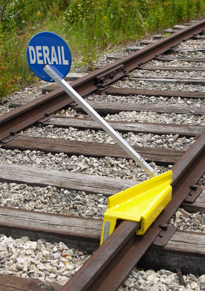 Sabertooth Right Throw Derail - Use on wooden ties only. Tie spacing: 18"-24" on center. Derails freight cars and all sizes of locomotives operating at switching speeds.  Height above rail 2.75". Fits rail from 90 to 141 lbs. per yd.  Weighs 35 lbs.